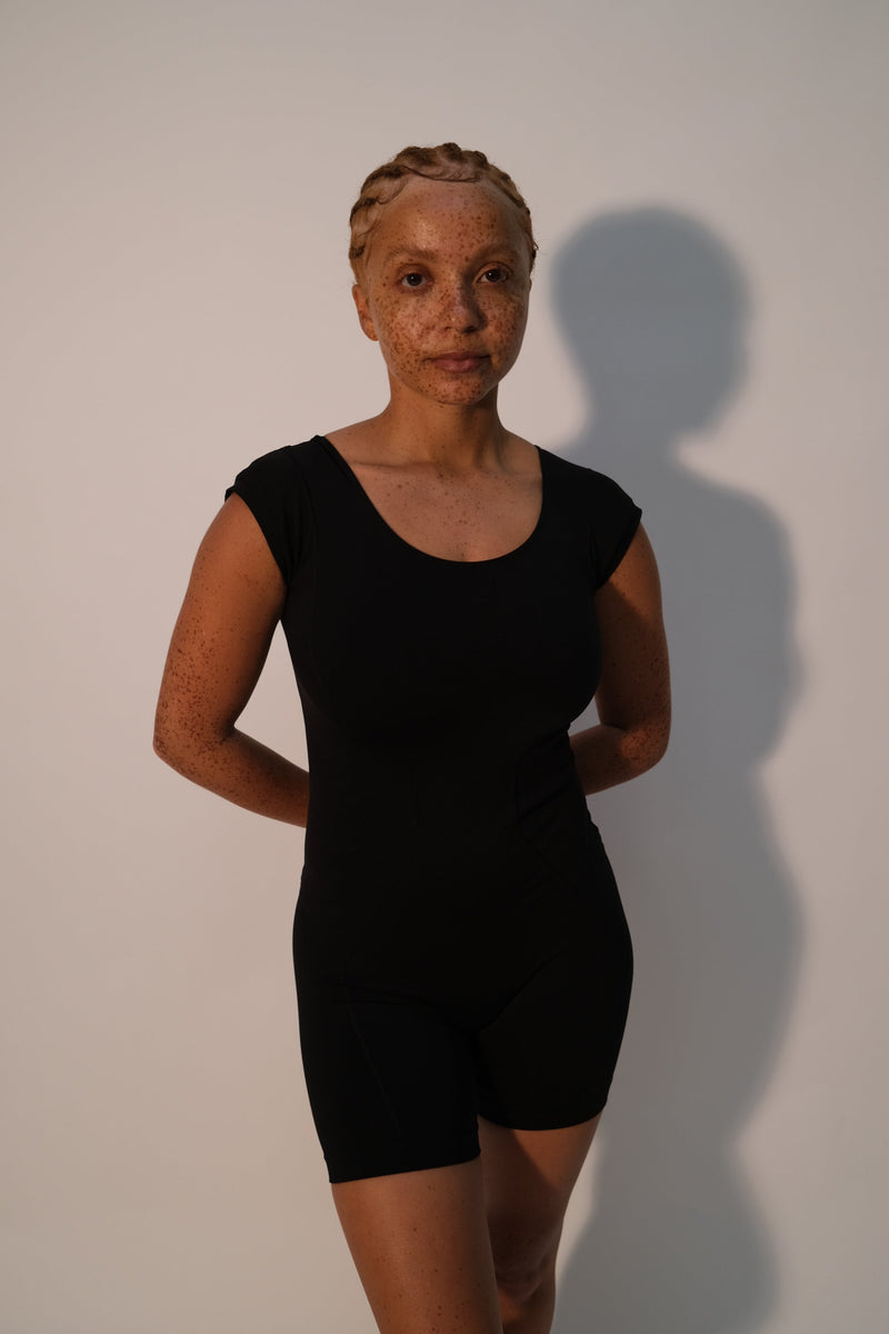 Model wears EUPHORIC unitard - Black - PRISM² - black unitard - plus size unitard -  Compression unitard - maternity playsuit