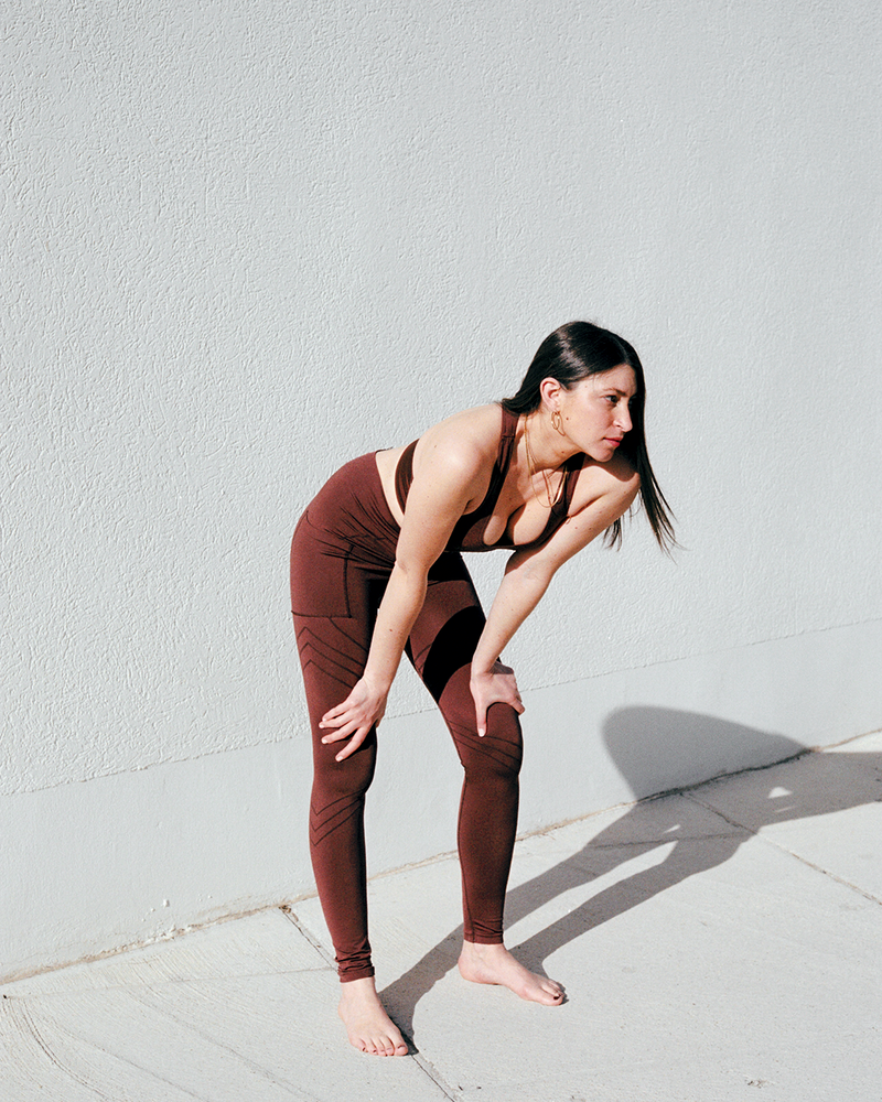 model wears vibrant leggings with a pocket - maroon leggings - ladies workout leggings- most flattering leggings - high waisted leggings - brown leggings - plus size woman leggings - curvy ladies leggings -